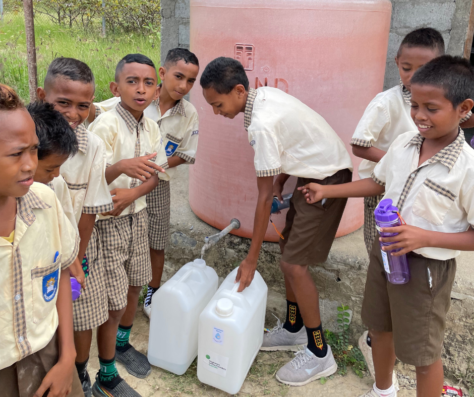 Children filling jerry can to then fill filters